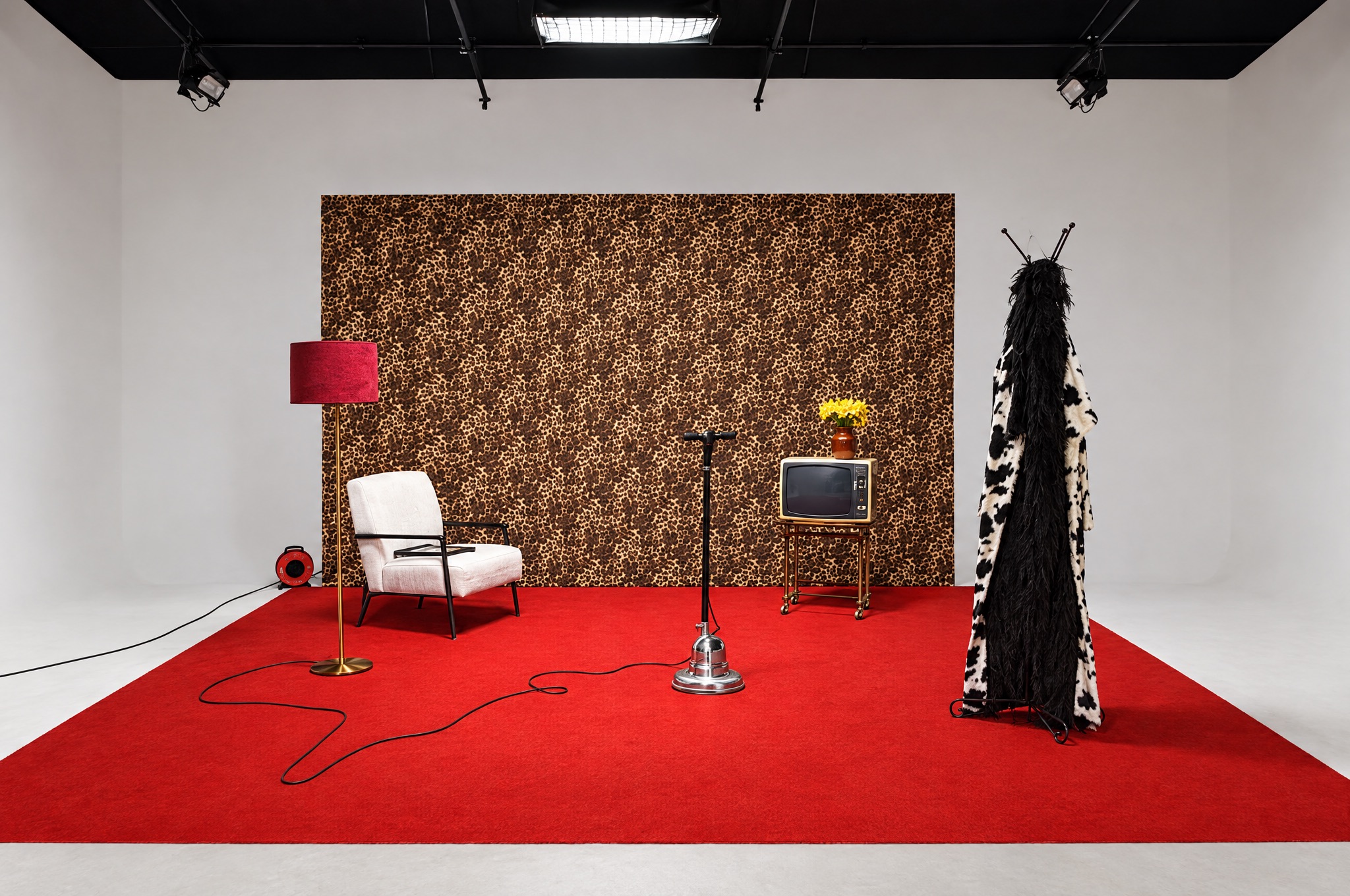 A set with a red floor and retro furniture